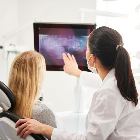 Emergency dentist explaining X-ray to patient